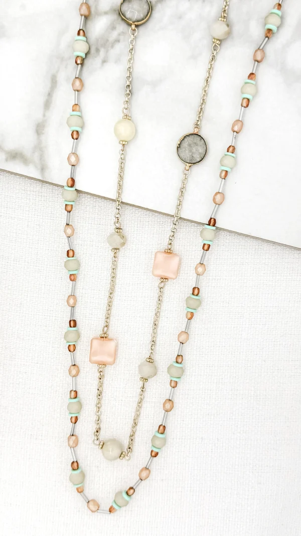 The Long Gold Double Layer Beaded Necklace with Semi Precious Stone Detail is a stylish and versatile accessory that adds a touch of elegance to any outfit. Its key features include a double layer design, gold-tone beads, and semi-precious stone accents. The necklace is not only visually appealing but also offers the benefit of being adjustable in length, allowing for customization to suit individual preferences. Its unique selling points lie in its combination of trendy layered style, luxurious gold finish, and the added touch of semi-precious stones, making it a standout piece for any occasion.
